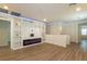 Open living room features wood-look flooring, a fireplace, and built-in shelving at 8446 Vacarez Dr, Las Vegas, NV 89149