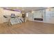 Open-concept living space with a modern fireplace, white built-ins, and an island kitchen at 8446 Vacarez Dr, Las Vegas, NV 89149