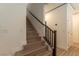 Staircase with wooden steps and a dark railing, leading to the upper level of the house at 8446 Vacarez Dr, Las Vegas, NV 89149