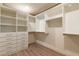 Spacious walk-in closet with custom white shelving and drawers providing ample storage space at 8446 Vacarez Dr, Las Vegas, NV 89149