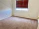 Simple bedroom with neutral carpet, and window with blinds at 9299 Adamshurst Ave, Las Vegas, NV 89148