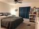 Bedroom featuring a queen bed, a ceiling fan, and a window with curtains at 9299 Adamshurst Ave, Las Vegas, NV 89148