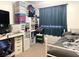 Bedroom featuring a full bed, white furniture, and a wall-mounted television at 9299 Adamshurst Ave, Las Vegas, NV 89148