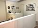 Upstairs hallway featuring a white half-wall with art and two doors at 9299 Adamshurst Ave, Las Vegas, NV 89148
