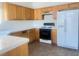 Well-equipped kitchen with white appliances, tile countertops, and ample cabinet space at 9299 Adamshurst Ave, Las Vegas, NV 89148