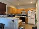 Kitchen with tile countertops, a breakfast bar, and white appliances at 9299 Adamshurst Ave, Las Vegas, NV 89148