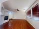 Spacious living room with fireplace, ceiling fan, hardwood floors and large windows at 9299 Adamshurst Ave, Las Vegas, NV 89148
