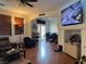 Living room with wood floors, recessed lighting, and large wall-mounted television at 9299 Adamshurst Ave, Las Vegas, NV 89148