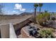 Desert backyard featuring a patio with seating, plants, and mountain views at 10491 Williamville Ct, Las Vegas, NV 89129