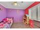 Bright bedroom featuring a closet, neutral carpet, and a shuttered window at 10218 Maltese Cross Ct, Las Vegas, NV 89183