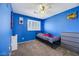 Cozy bedroom featuring a ceiling fan, window shutters, and carpet flooring at 10218 Maltese Cross Ct, Las Vegas, NV 89183