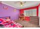 Bright bedroom with unique color accents, neutral carpet, and a shuttered window at 10218 Maltese Cross Ct, Las Vegas, NV 89183