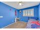 Inviting bedroom with a ceiling fan, shuttered window, and neutral carpet flooring at 10218 Maltese Cross Ct, Las Vegas, NV 89183