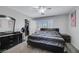 Comfortable main bedroom with neutral carpet, a ceiling fan, and plenty of closet space at 10218 Maltese Cross Ct, Las Vegas, NV 89183