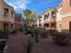 Charming condo community featuring well-maintained desert landscaping and inviting exterior design with multiple units visible at 10525 Autumn Pine Ave # 203, Las Vegas, NV 89144