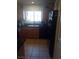 Kitchen with stainless steel appliances, wooden cabinets, and tile flooring at 10525 Autumn Pine Ave # 203, Las Vegas, NV 89144