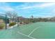 Community basketball court featuring newly painted lines, a perimeter fence, and nearby community recreation facilities at 11002 Inverlochy Ct, Las Vegas, NV 89141