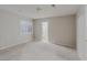 Spacious bedroom with neutral walls and carpet, a window with shutters and an attached bathroom at 11002 Inverlochy Ct, Las Vegas, NV 89141