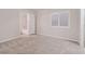 Bedroom featuring neutral walls, neutral carpet, a window with shutters and an attached bathroom at 11002 Inverlochy Ct, Las Vegas, NV 89141