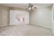 Light and airy bedroom with neutral carpet, double door entry, and a ceiling fan at 11002 Inverlochy Ct, Las Vegas, NV 89141