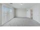 Large bonus room has neutral carpeting, a window with shutters, and a nearby doorway with an open door at 11002 Inverlochy Ct, Las Vegas, NV 89141