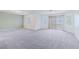 Spacious bonus room with plush carpet, large windows, and a sliding glass door at 11002 Inverlochy Ct, Las Vegas, NV 89141