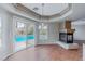 Dining area featuring a fireplace, tile floors, and sliding glass doors leading to the pool at 11002 Inverlochy Ct, Las Vegas, NV 89141