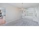 Open dining room with a chandelier, neutral paint, and carpet at 11002 Inverlochy Ct, Las Vegas, NV 89141