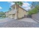 Exterior featuring a paver driveway, secure gate, and a three-car garage at 11002 Inverlochy Ct, Las Vegas, NV 89141