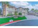 Charming two-story home showcasing lush landscaping, a paver driveway, and a three-car garage at 11002 Inverlochy Ct, Las Vegas, NV 89141