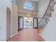 Inviting foyer showcasing double doors, high ceilings, and a curved staircase at 11002 Inverlochy Ct, Las Vegas, NV 89141