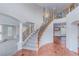 Grand foyer featuring high ceilings, a curved staircase, and elegant tile flooring at 11002 Inverlochy Ct, Las Vegas, NV 89141