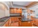 Gourmet kitchen with granite countertops, stainless steel refrigerator, and wooden cabinetry at 11002 Inverlochy Ct, Las Vegas, NV 89141