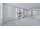 Bright living room with a modern fireplace, neutral paint, shutters, and carpet at 11002 Inverlochy Ct, Las Vegas, NV 89141