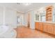 Spacious bathroom featuring a soaking tub, dual vanities, and tile flooring at 11002 Inverlochy Ct, Las Vegas, NV 89141