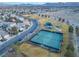 Aerial view of community tennis courts with recreation fields nearby, as well as well manicured streets and foliage at 11002 Inverlochy Ct, Las Vegas, NV 89141