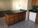 Open concept kitchen with green countertops and wood cabinets at 1105 Sulphur Springs Ln # 102, Las Vegas, NV 89128