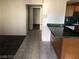 View of the kitchen with wood cabinets, a breakfast bar, and tiled floors at 1105 Sulphur Springs Ln # 102, Las Vegas, NV 89128