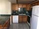 Kitchen featuring wood cabinets, green countertops, and white appliances at 1105 Sulphur Springs Ln # 102, Las Vegas, NV 89128