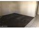 Empty living room with tiled floors and large carpet square at 1105 Sulphur Springs Ln # 102, Las Vegas, NV 89128