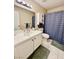 This bathroom has a shower-tub, single sink vanity, white medicine cabinet, and tile flooring at 1105 Sulphur Springs Ln # 202, Las Vegas, NV 89128