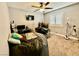 Cozy bedroom with ceiling fan, carpet flooring, window with shutters, and furniture at 1105 Sulphur Springs Ln # 202, Las Vegas, NV 89128