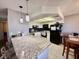 Bright kitchen featuring granite countertops, modern appliances, and pendant lighting over the breakfast bar at 1105 Sulphur Springs Ln # 202, Las Vegas, NV 89128
