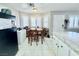 Bright kitchen with granite counters, white cabinets, and dining area with shuttered windows at 1105 Sulphur Springs Ln # 202, Las Vegas, NV 89128
