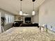 Cozy living area featuring stone fireplace, shuttered windows, and stylish pendant lights at 1105 Sulphur Springs Ln # 202, Las Vegas, NV 89128
