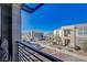 Inviting balcony view of a modern community with townhomes and street parking at 1135 Tektite Ave, Henderson, NV 89011