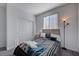 A cozy bedroom with a large window, closet, and contemporary furnishings provides ample storage at 1135 Tektite Ave, Henderson, NV 89011