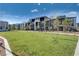 Expansive green space in a common area, framed by contemporary homes and young trees, promoting outdoor enjoyment at 1135 Tektite Ave, Henderson, NV 89011