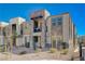 Contemporary townhome with a stone exterior, a quaint balcony, and desert-friendly landscaping at 1135 Tektite Ave, Henderson, NV 89011