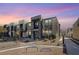 Beautiful modern townhome exterior featuring unique architecture with stone accents under a vibrant sunset at 1135 Tektite Ave, Henderson, NV 89011